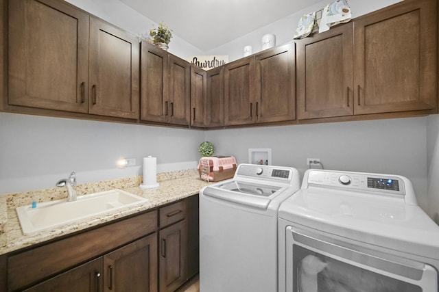 laundry area featuring cabinets, washing machine and clothes dryer, and sink