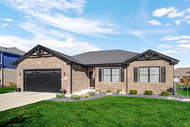 view of front of home featuring a front yard and a garage