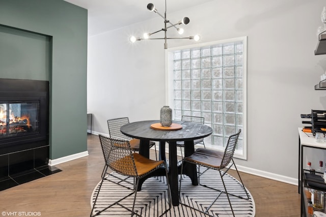 dining room featuring plenty of natural light, dark wood-type flooring, and a chandelier