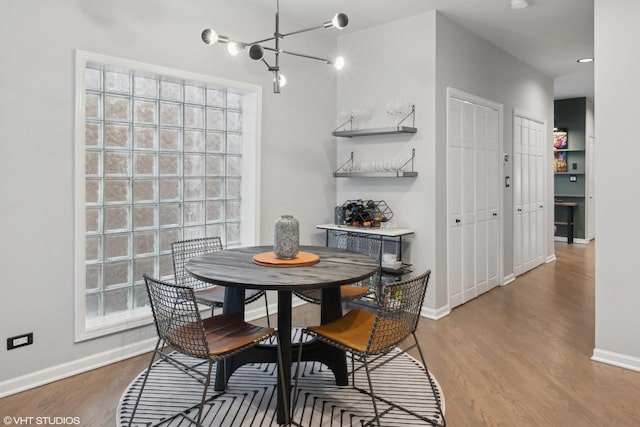 dining room with a chandelier and hardwood / wood-style flooring