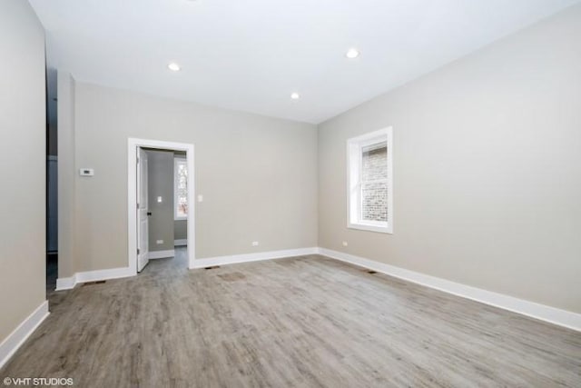 empty room with hardwood / wood-style flooring