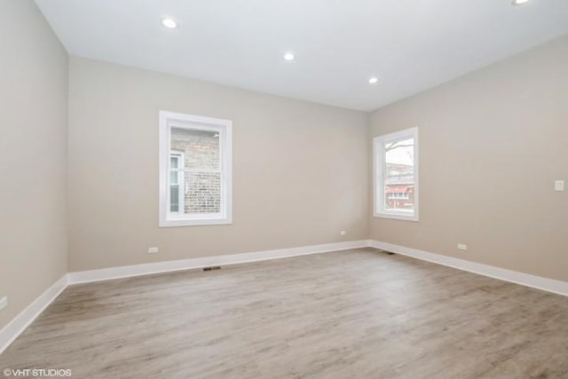 spare room with light hardwood / wood-style flooring