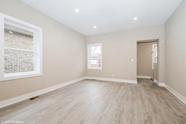 spare room featuring light hardwood / wood-style floors