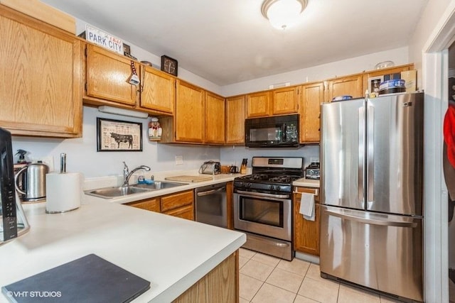 kitchen with sink, appliances with stainless steel finishes, and light tile patterned flooring