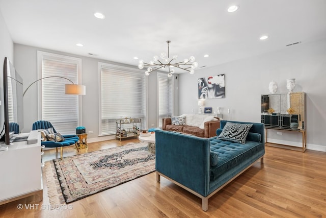 living room featuring a chandelier and wood-type flooring