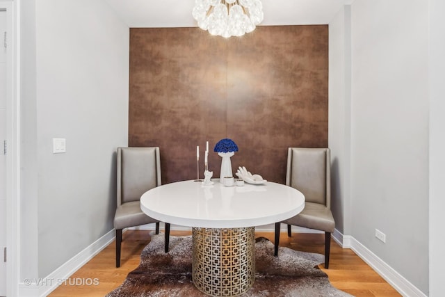 dining area featuring an inviting chandelier and hardwood / wood-style floors