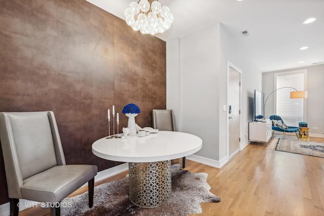 sitting room with light hardwood / wood-style flooring and a chandelier