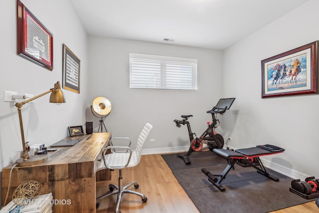 workout area with hardwood / wood-style flooring