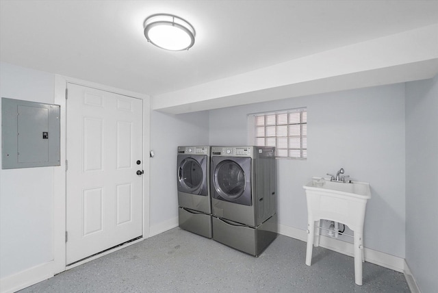 laundry room featuring electric panel, sink, and washing machine and dryer