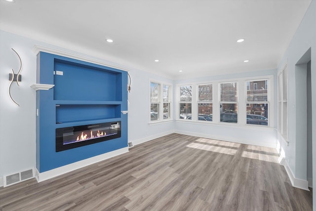 unfurnished living room featuring wood-type flooring