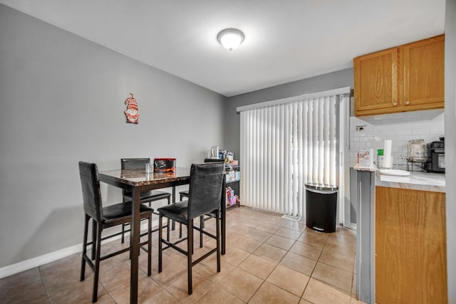 dining space featuring light tile patterned floors