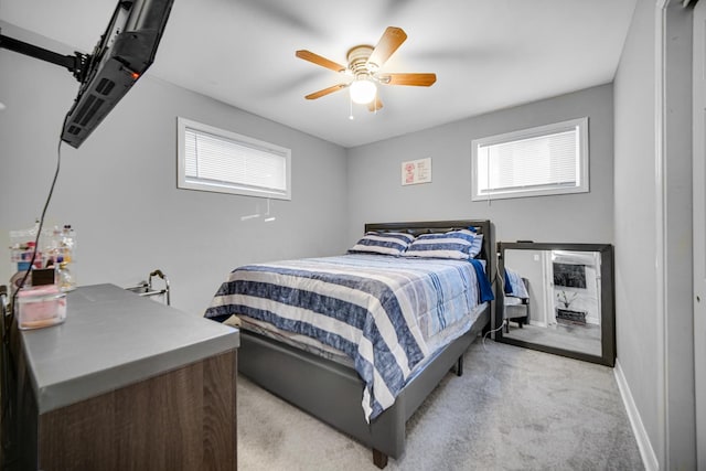 bedroom with ceiling fan and light colored carpet