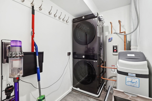 laundry area with water heater and stacked washer and dryer