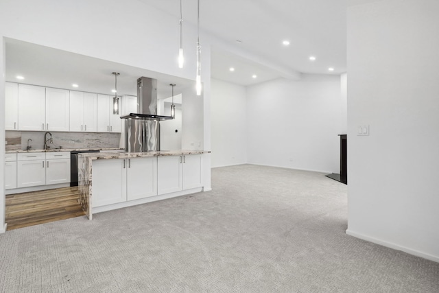 kitchen with decorative light fixtures, light colored carpet, white cabinets, and island range hood