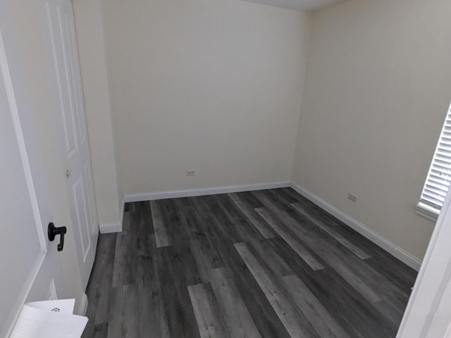 spare room featuring dark hardwood / wood-style flooring