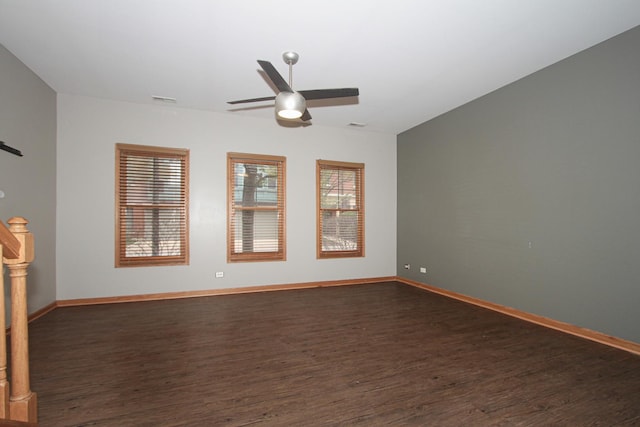 spare room with ceiling fan and dark hardwood / wood-style flooring