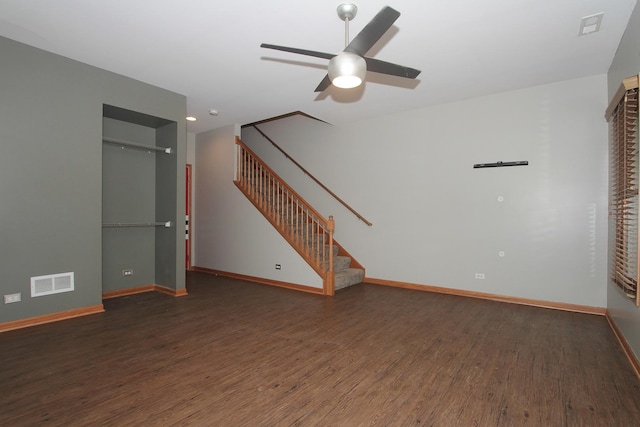 empty room featuring ceiling fan and dark wood-type flooring