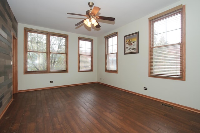 empty room featuring ceiling fan and dark wood-type flooring