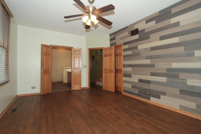 unfurnished bedroom with ceiling fan and dark hardwood / wood-style flooring