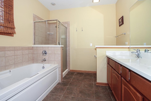 bathroom with tile patterned floors, vanity, and separate shower and tub