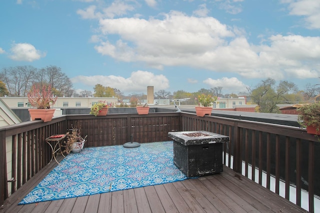 wooden deck with a fire pit