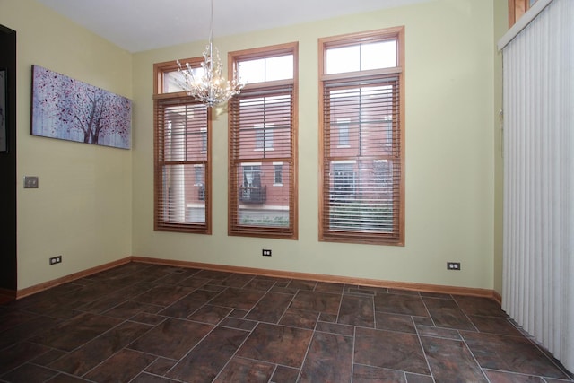 unfurnished dining area with an inviting chandelier