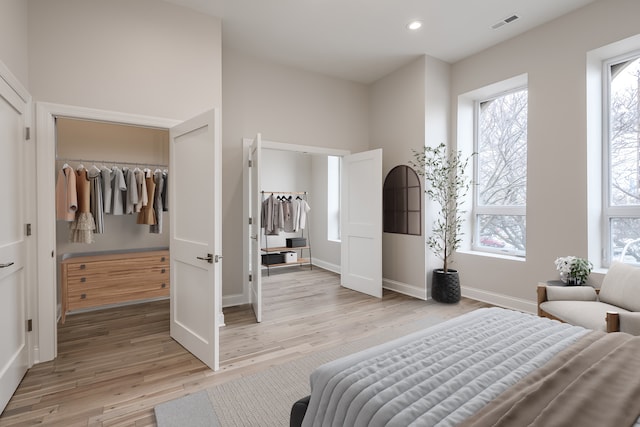 bedroom with a closet and light hardwood / wood-style floors