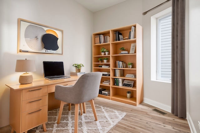 office area with plenty of natural light and light hardwood / wood-style floors