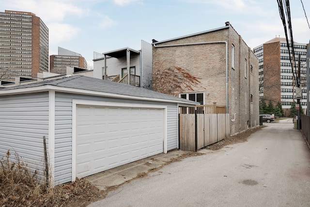 exterior space featuring a garage and an outbuilding