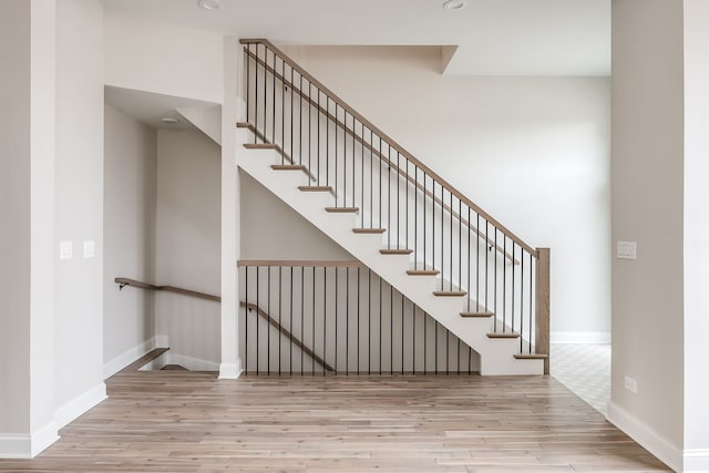 staircase featuring wood-type flooring