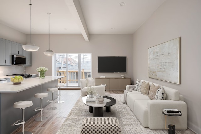 living room with beamed ceiling and light hardwood / wood-style flooring