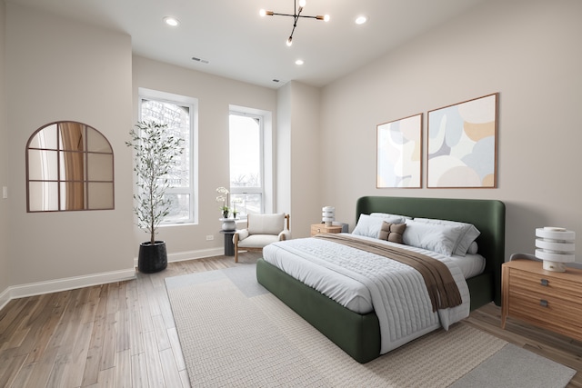 bedroom featuring hardwood / wood-style floors and a notable chandelier