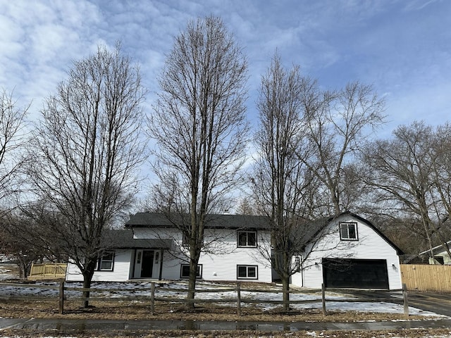 view of front facade featuring a garage and fence