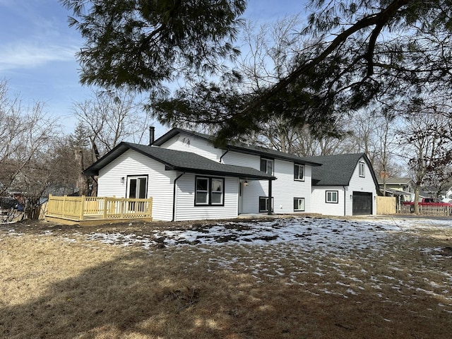 view of front of house with a garage, roof with shingles, and a wooden deck