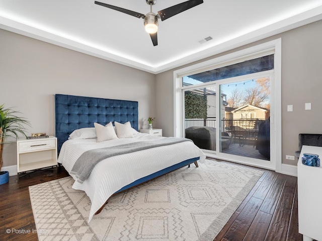 bedroom featuring access to exterior, visible vents, dark wood-type flooring, a ceiling fan, and baseboards