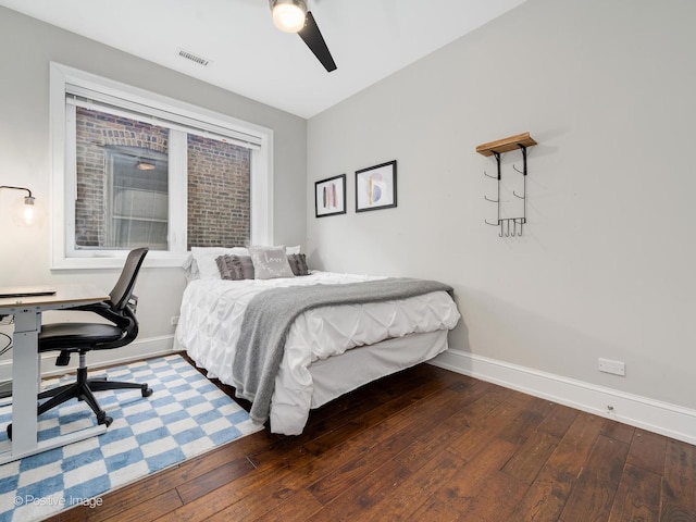 bedroom featuring hardwood / wood-style floors, visible vents, and baseboards