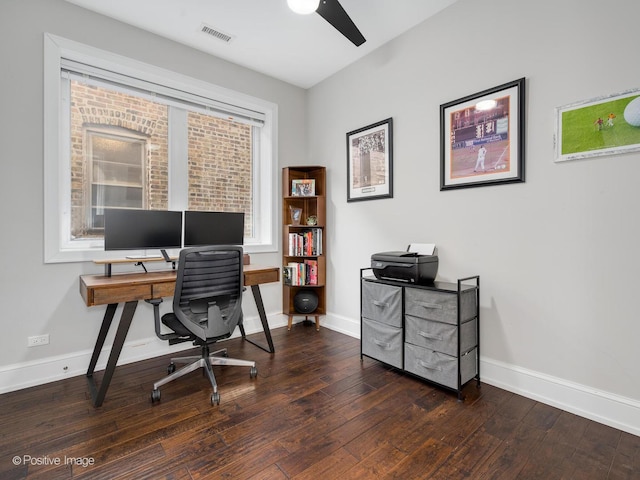 office space featuring dark wood-style floors, visible vents, ceiling fan, and baseboards