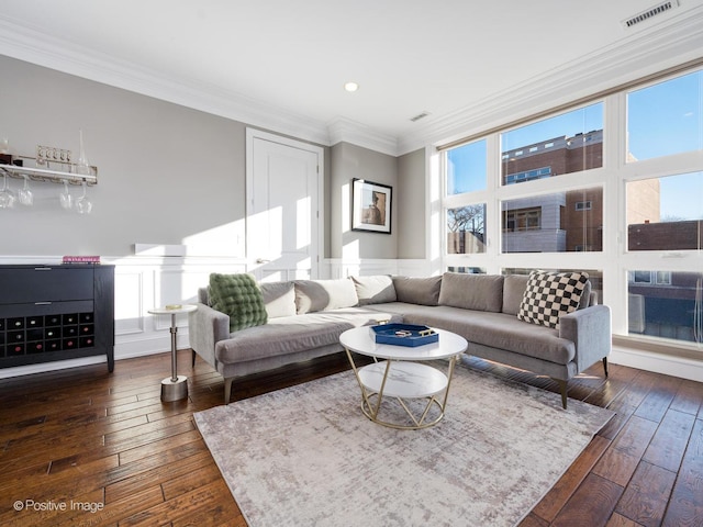 living room with dark wood-type flooring, visible vents, and ornamental molding