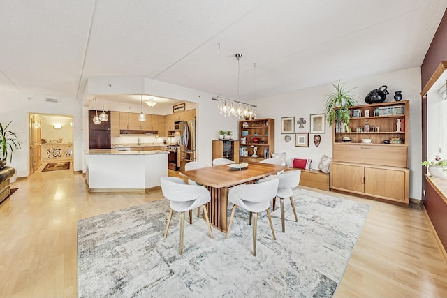 dining area with light hardwood / wood-style floors