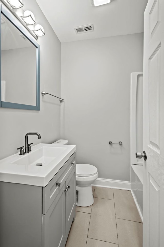 bathroom featuring tile patterned flooring, vanity, and toilet