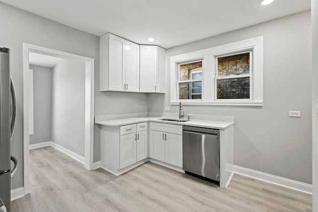 kitchen featuring sink, white cabinetry, stainless steel appliances, and light wood-type flooring