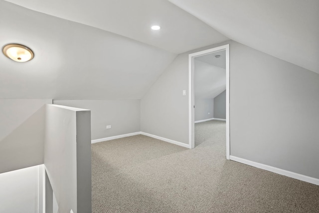 additional living space with carpet floors and lofted ceiling