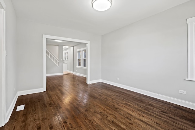 unfurnished room with dark hardwood / wood-style floors