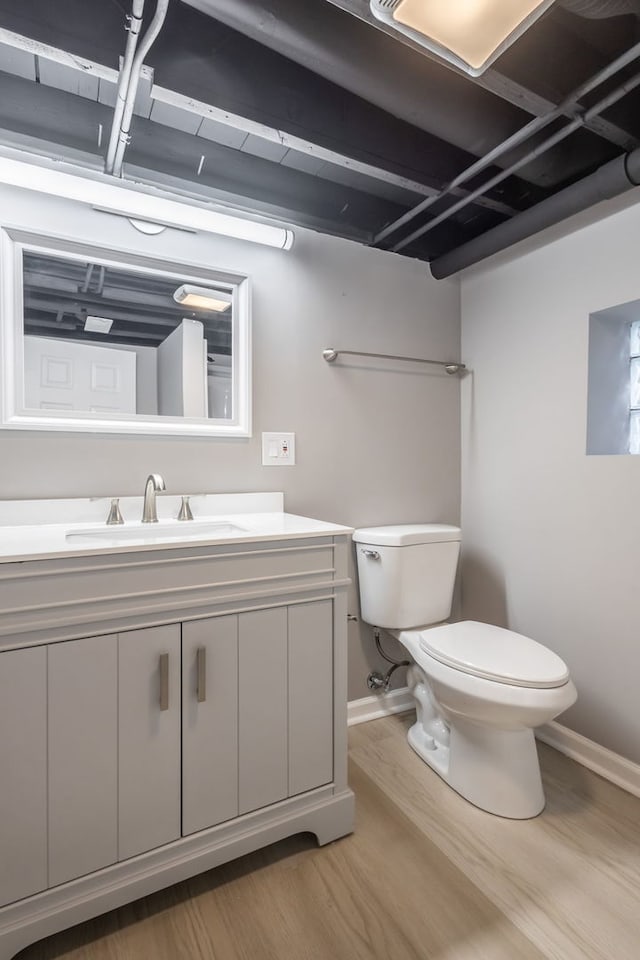 bathroom featuring hardwood / wood-style floors, vanity, and toilet