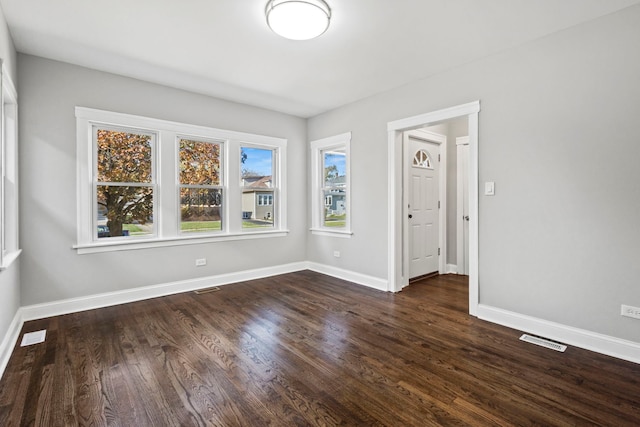 spare room featuring dark wood-type flooring