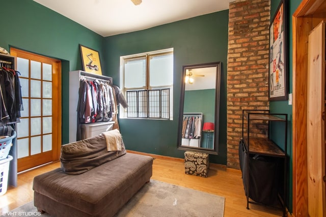 interior space with ceiling fan, baseboards, and wood finished floors