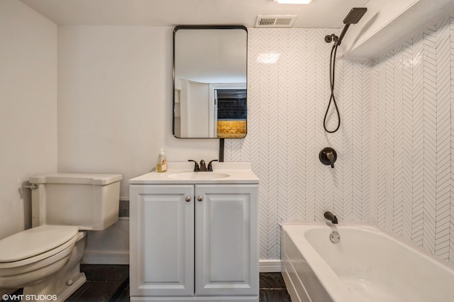 full bath with baseboards, visible vents, toilet, bathtub / shower combination, and vanity