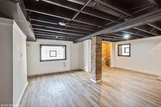 below grade area with wood finished floors and baseboards