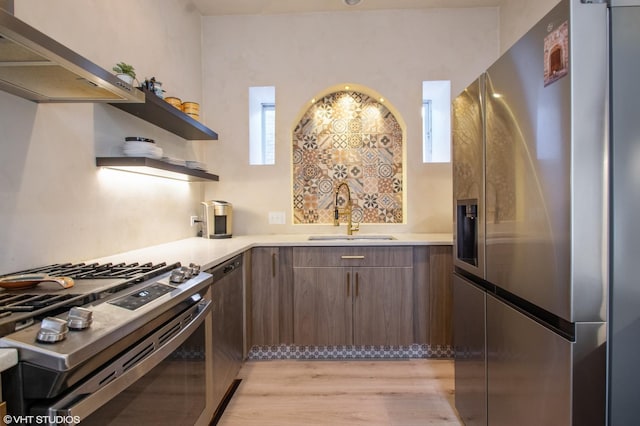 kitchen featuring appliances with stainless steel finishes, extractor fan, light countertops, open shelves, and a sink