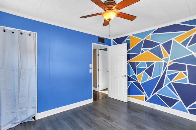 empty room featuring dark hardwood / wood-style floors, ceiling fan, and ornamental molding